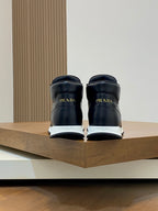 Prada sneakers from the back, dark uppers with heel branding.
