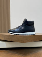 Prada dark leather sneakers, side view with lace-up and logo on upper.
