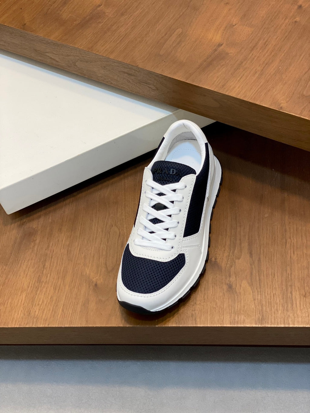 White and navy unisex lace-up sneakers with padded collar and side stripe panels