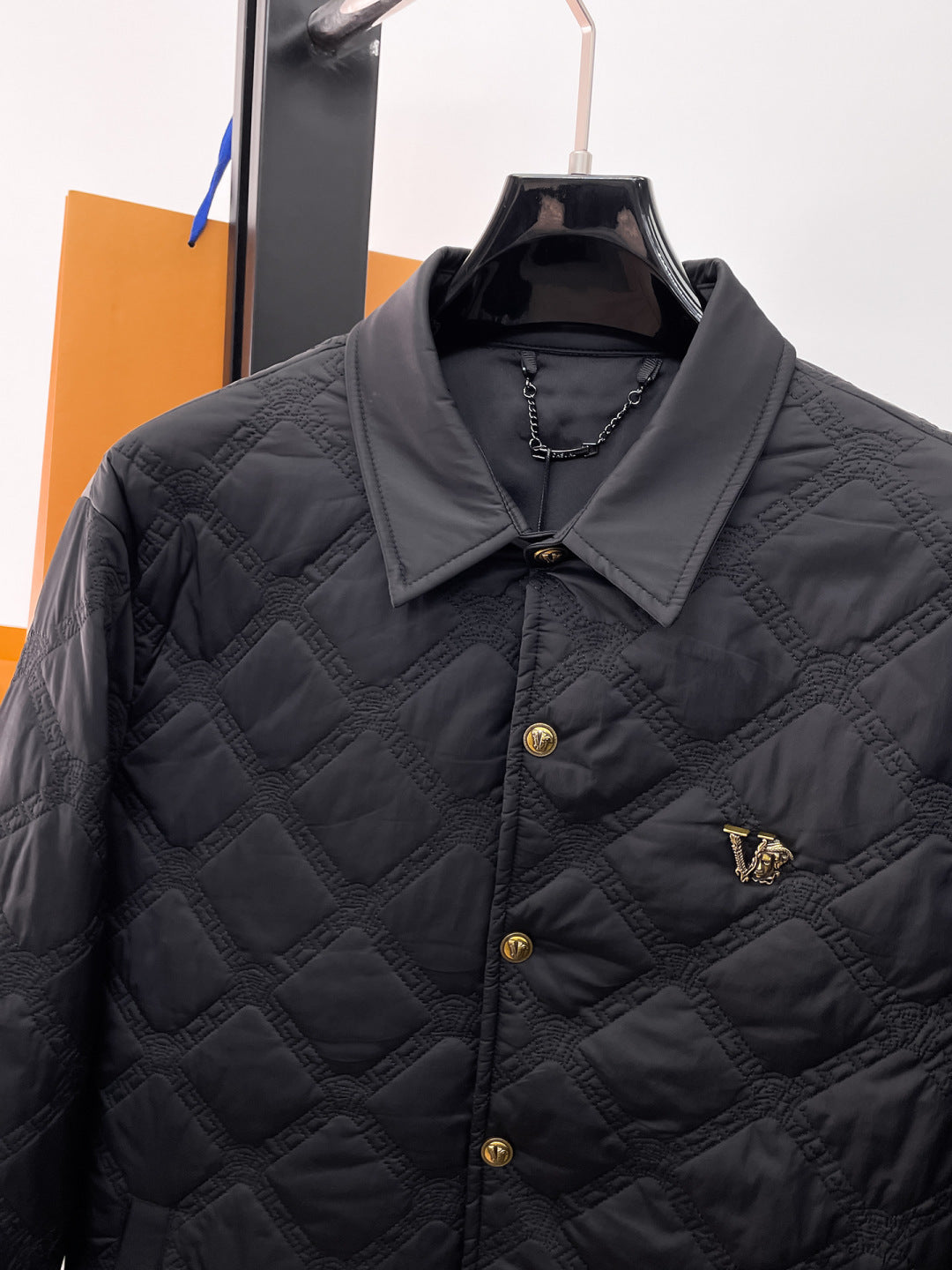 Versace quilted jacket with stand collar, gold buttons, and chest logo patch