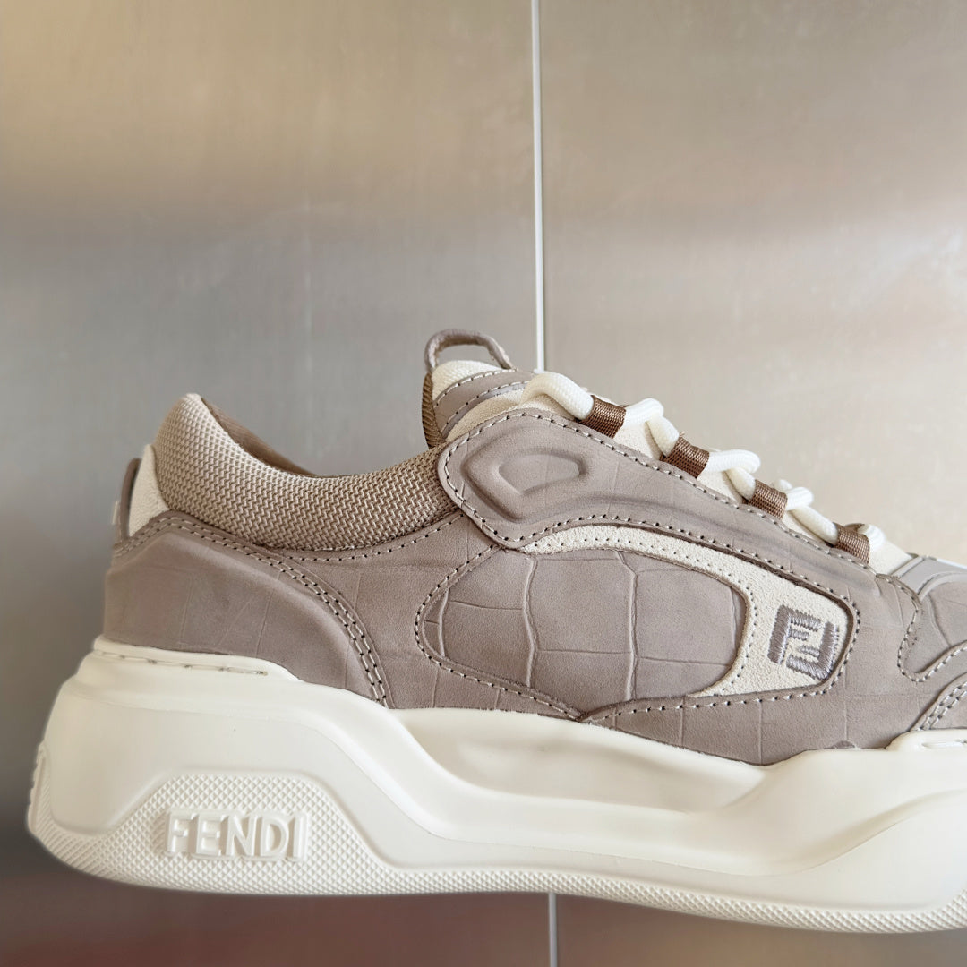 Taupe Fendi low-top sneaker close-up, side panel and white laces