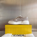 Taupe Fendi low-top sneaker with white sole, side profile on a box