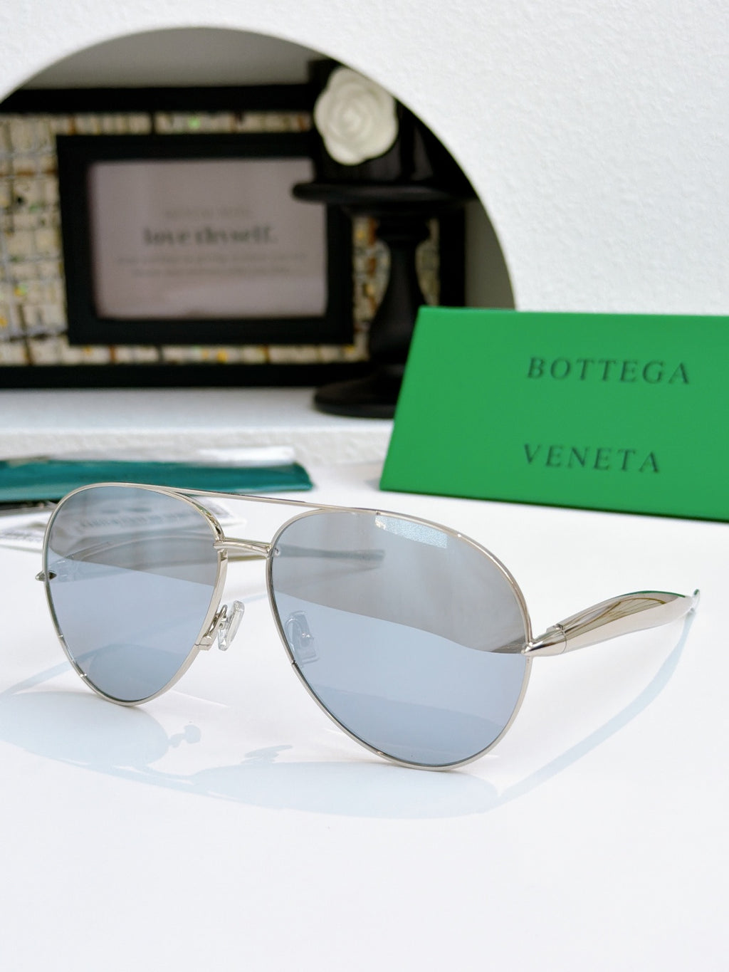Bottega Veneta aviator sunglasses with silver frame and light blue tinted lenses