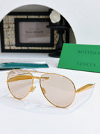 Bottega Veneta sunglasses with gold frame and amber tinted lenses