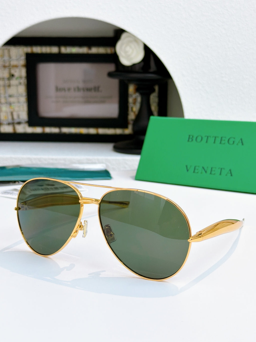 Bottega Veneta aviator sunglasses with gold frame and green tinted lenses