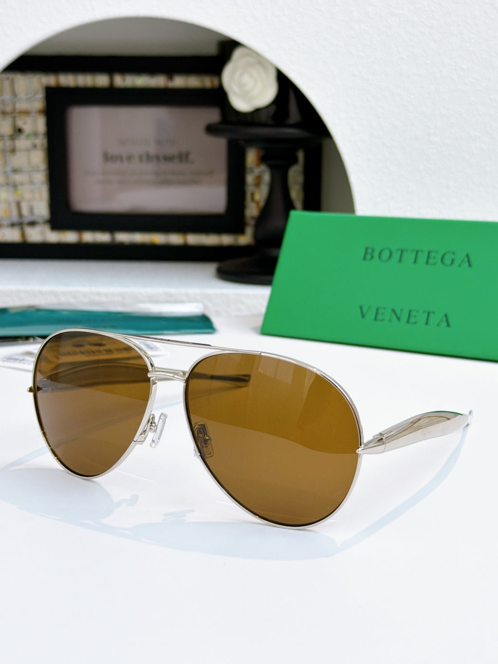 Bottega Veneta sunglasses with gold frame and brown tinted lenses