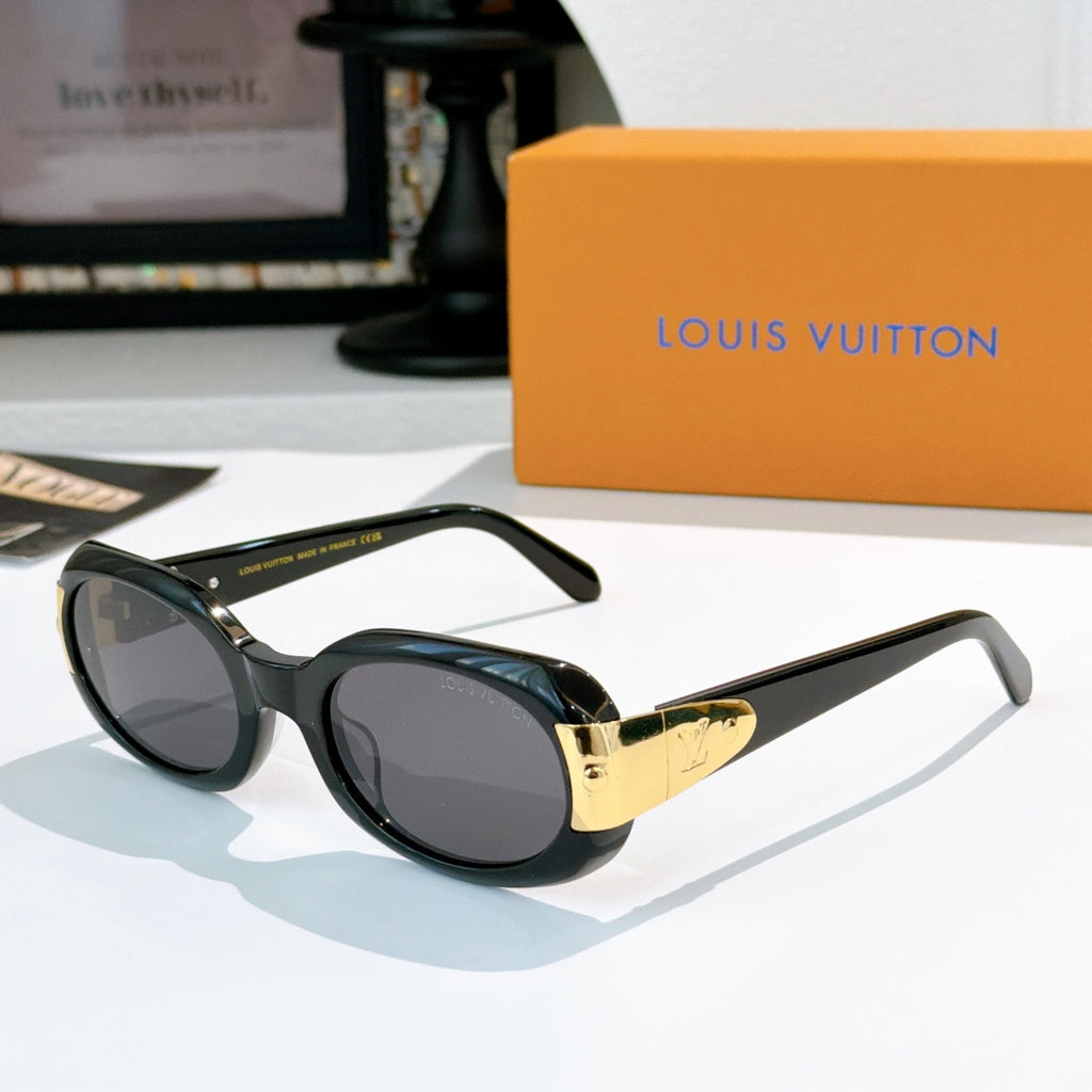 Sunglasses with dark frames and gold-tone logo bridge, tinted gray lenses
