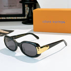 Sunglasses with dark frames and gold-tone logo bridge, tinted gray lenses