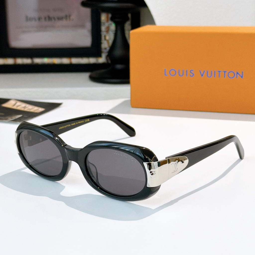 Sunglasses with dark green frames and gold-tone bridge, oval lenses