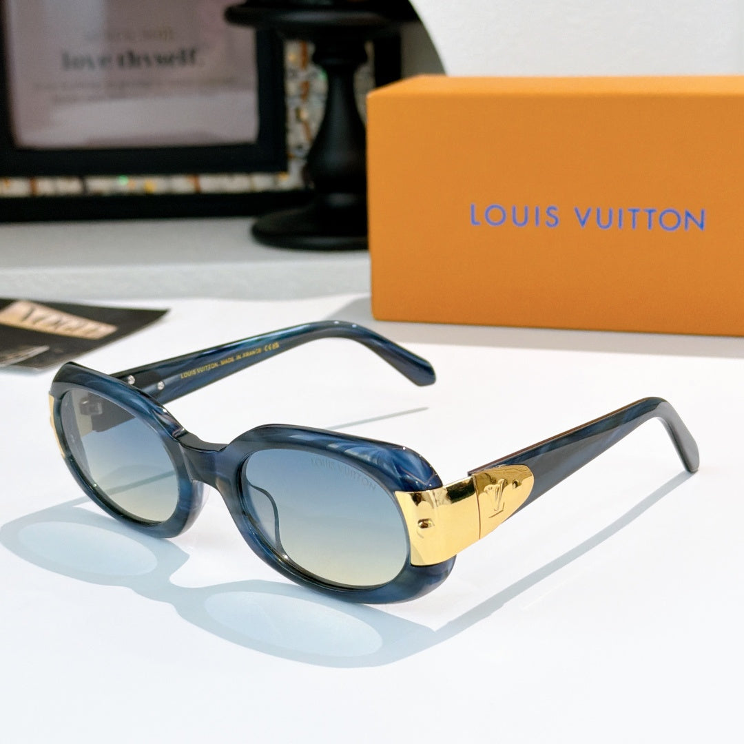 Sunglasses with navy-blue frames and gold-tone logo bridge, light tinted lenses
