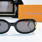 Louis Vuitton sunglasses with black oval frames and gold logo hinge details