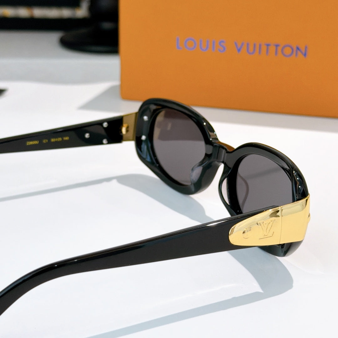 Louis Vuitton sunglasses with round black frames, dark lenses, gold bar detail