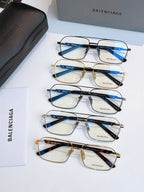 Assorted eyeglasses with blue-tinted lenses and mixed gold and black frames.