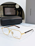 Gold metal eyeglasses with clear lenses and black temple accents.
