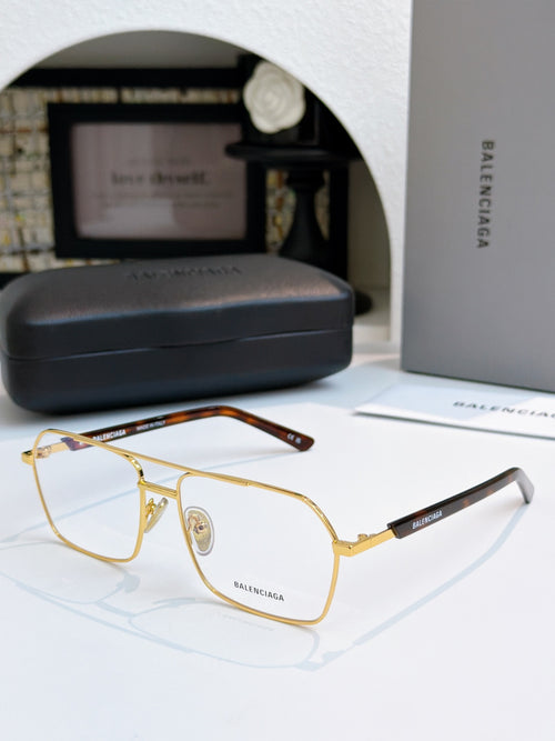 Gold metal eyeglasses with clear lenses and black temple accents.