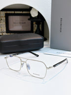 Silver metal eyeglasses with clear lenses and black temple text.