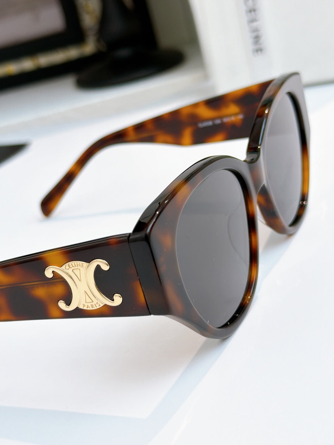 Celine cat-eye sunglasses with tortoiseshell frame and dark lenses, gold logo on side