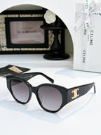 Celine cat-eye sunglasses with black frame and dark lenses, gold logo on side