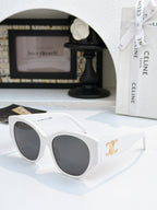 Celine cat-eye sunglasses with white frame and dark lenses, gold logo on temple