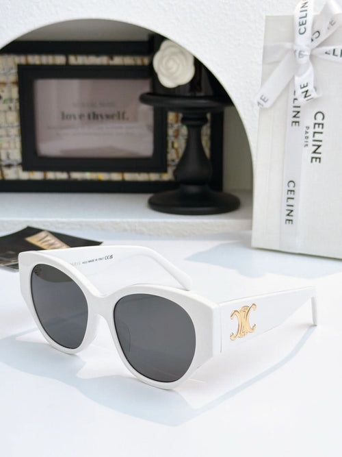 Celine cat-eye sunglasses with white frame and dark lenses, gold logo on temple