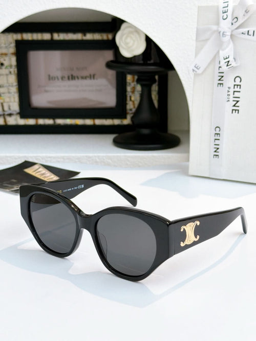 Celine cat-eye sunglasses with black frame and dark lenses, gold emblem on temple