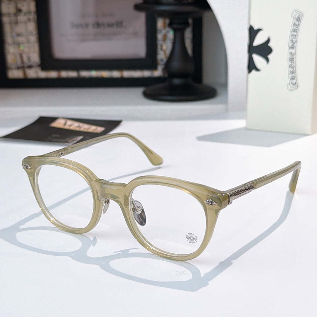 Olive-beige round glasses with gold-toned accents and patterned temples