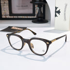 Tortoiseshell round glasses with gold-toned hinge details and decorative temples