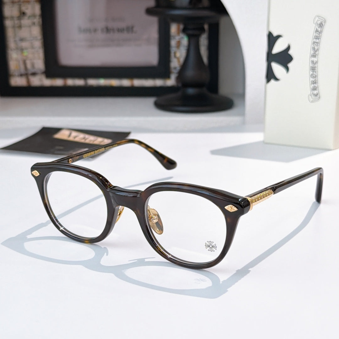 Tortoiseshell round glasses with gold-toned hinge details and decorative temples