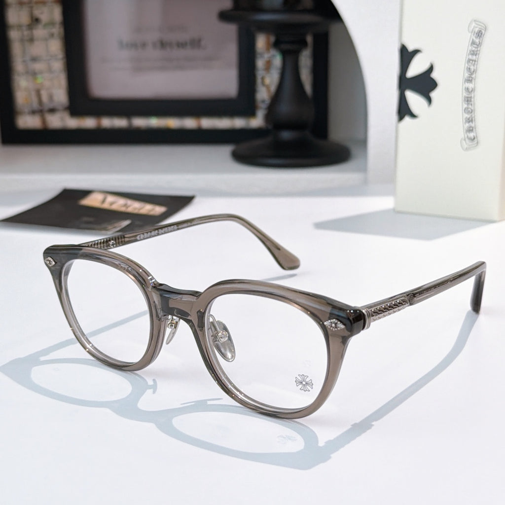 Gray round glasses with gold-toned accents and patterned temples