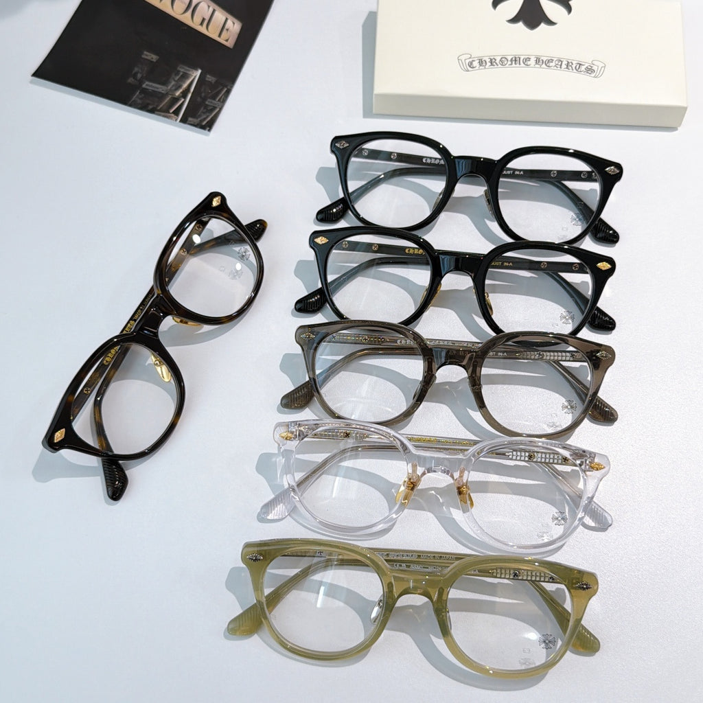 Assorted round glasses frames in black, gray, clear, and olive with gold-toned details