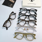 Assorted round glasses frames in black, gray, clear, and olive with gold-toned details