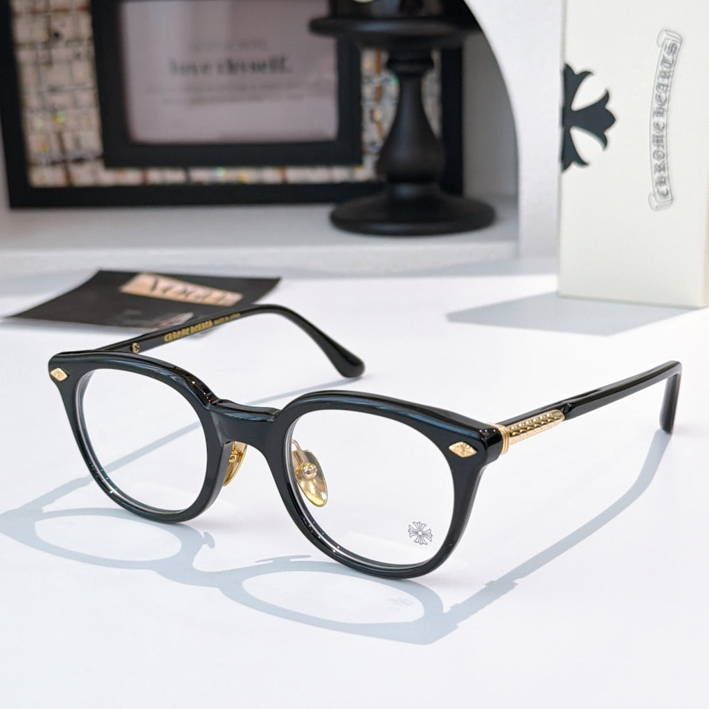 Dark blue round glasses with gold-toned details and star emblem on lens