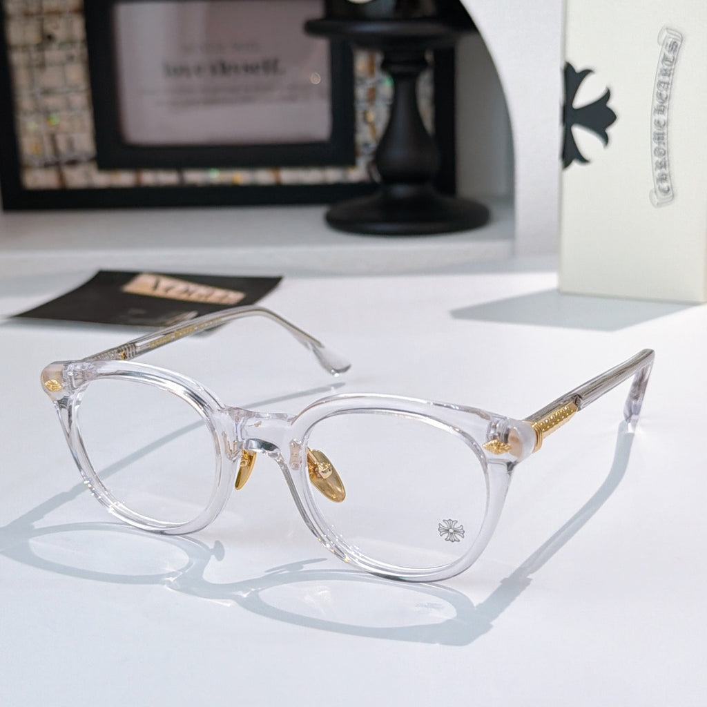 Clear round glasses with gold-toned hinge accents and decorative temples