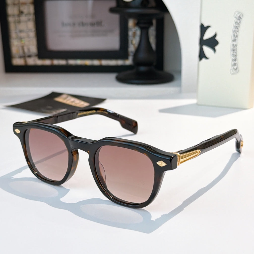 Brown sunglasses with rose-tinted lenses and gold logo accents.