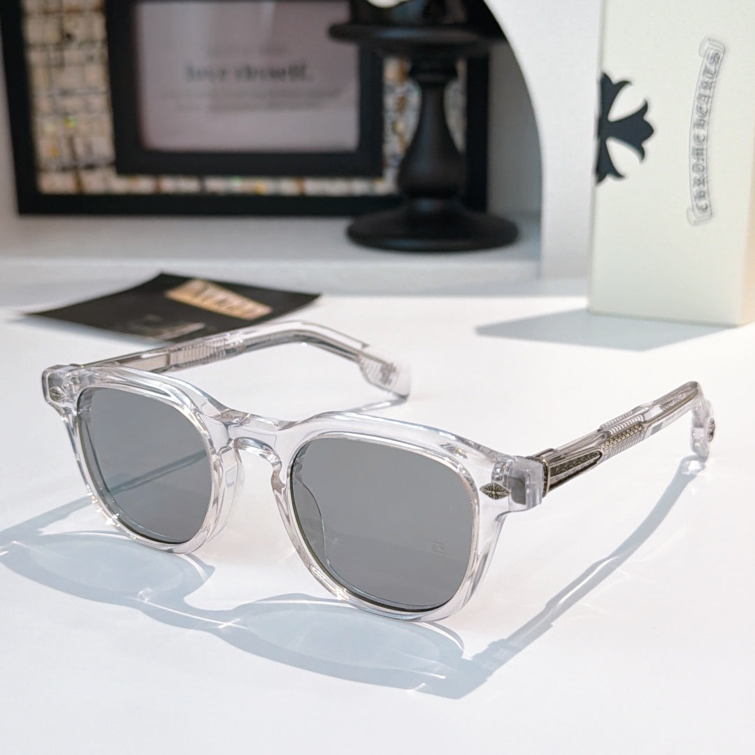 Transparent sunglasses with gray-tinted lenses and silver-tone logo accents.