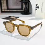 Amber sunglasses with tan-tinted lenses and gold logo accents.