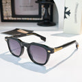Black sunglasses with purple-tinted lenses and gold logo accents.