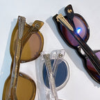 Assorted sunglasses showing amber, clear, and black frames with colored lenses.