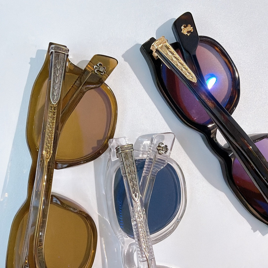 Assorted sunglasses showing amber, clear, and black frames with colored lenses.