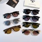 Assorted sunglasses with black, clear, green, and brown frames laid flat.