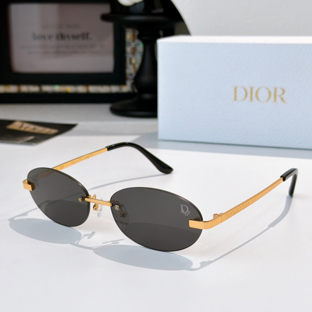 Dior sunglasses with gold-tone metal frame and dark gray oval lenses