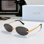 Dior sunglasses with gold-tone metal frame and dark gray oval lenses