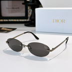 Dior sunglasses with gold-tone frame and dark gray mirrored oval lenses