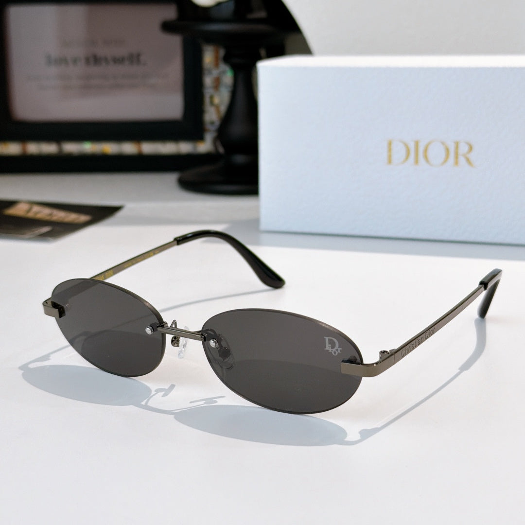 Dior sunglasses with gold-tone frame and dark gray mirrored oval lenses
