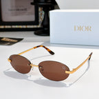 Dior sunglasses with gold-tone frame and brown oval lenses with orange temple tips