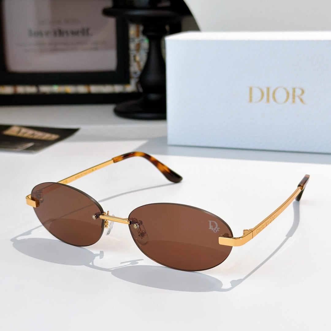 Dior sunglasses with gold-tone frame and brown oval lenses with orange temple tips
