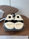 Balenciaga shearling sandals with black straps and cream fuzzy footbed, pair on box