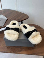 Balenciaga slide sandals with cream shearling straps and black buckled band, on box