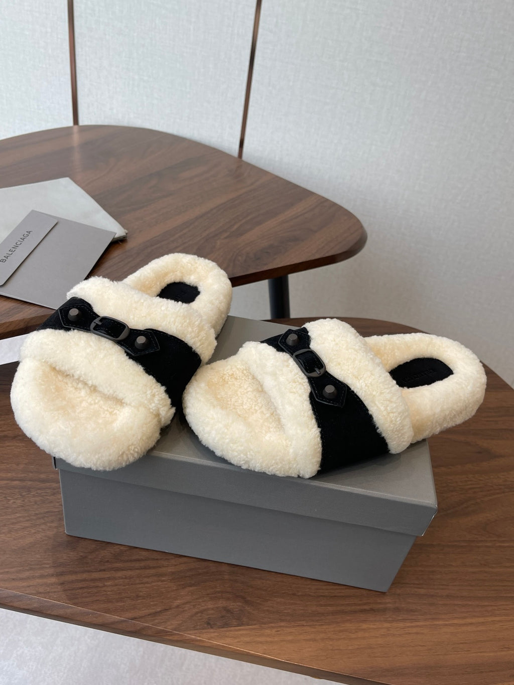 Balenciaga fuzzy slide sandals with black straps and cream shearling, pair on box