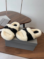 Balenciaga fuzzy slide sandals with black straps and cream shearling, pair on box